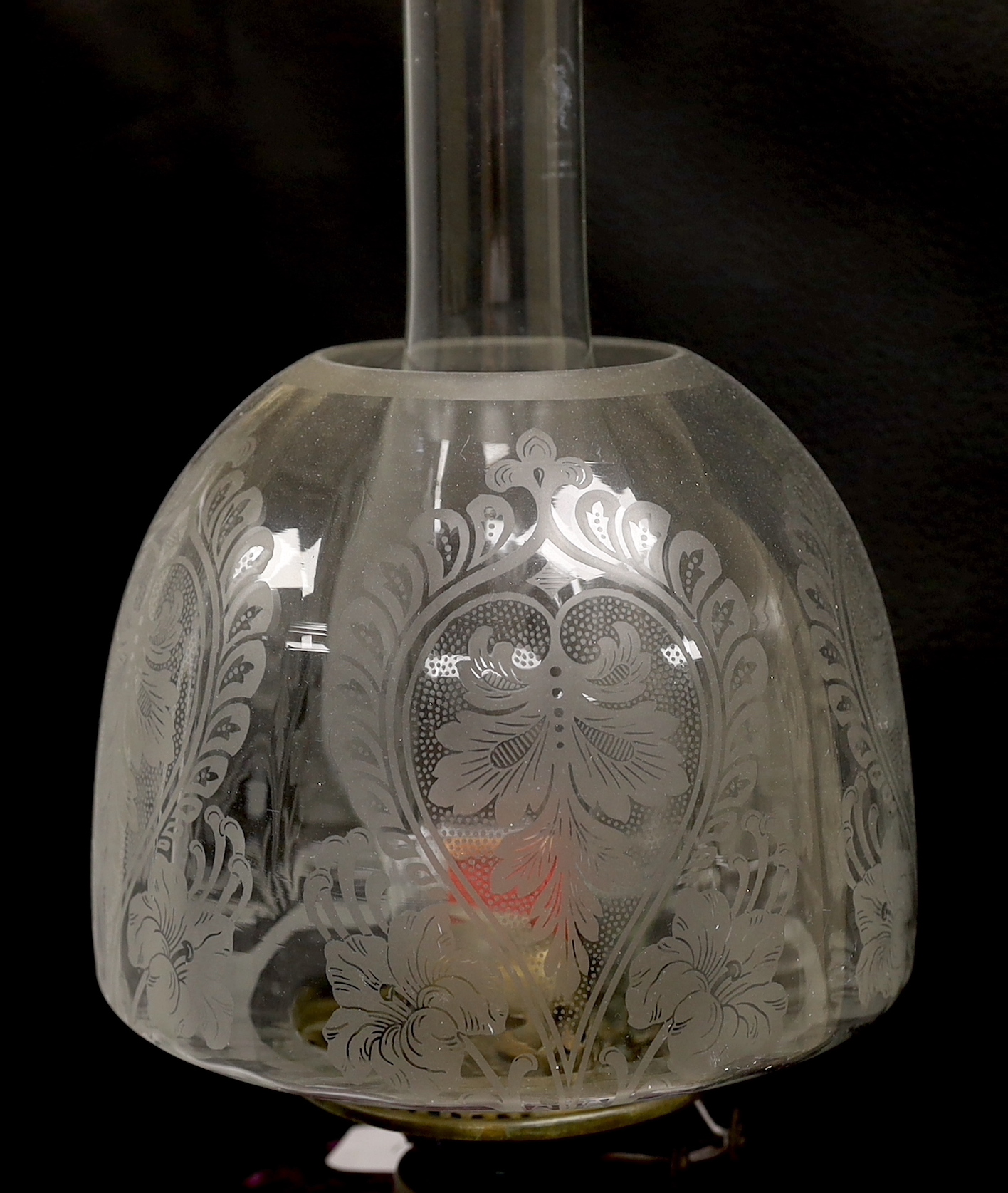 A Victorian oil lamp with an amethyst floral enamelled glass bowl and clear etched shade, 65cm high